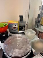 Overview: boxed pressure cooker, juicer, platter stack, mixing bowl, toaster