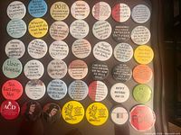 Thirty assorted quote and themed buttons arranged in grid