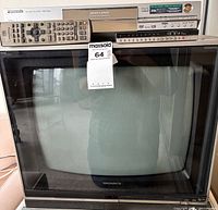 Front view showing Magnavox CRT TV, Panasonic recorder stacked on top, both remotes