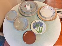 Mixed dinnerware laid out on table showing all patterns and quantities