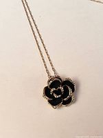 Full view of necklace showing chain and rose pendant