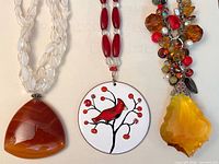 Overview of three pendant necklaces side by side