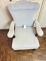 Front view of upholstered accent armchair showing seat, arms, legs