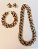 Full set laid out showing necklace, bracelet, earrings on white background