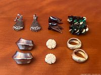 All six pairs of clip-on earrings laid out for full view of styles and colours