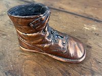 Angled view showing boot shape, lace detail, patina