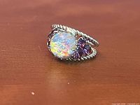 Front view highlighting cabochon and purple stones