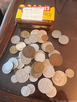 Coins spread beside Meggzones tin