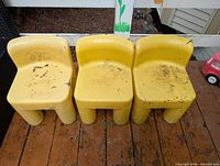 Front view of three yellow Little Tikes chairs