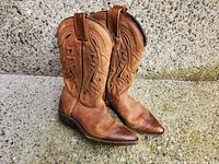 Rightmost pair of tan cowboy boots standing side view