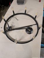 Top view of circular chandelier showing eight bulbs and wiring