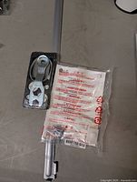 Full kit showing aluminum rail, bracket assembly, sealed hardware bag with LG instructions