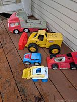 All six Little Tikes vehicles grouped on deck