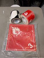 Two rolls and pack: blank label roll, flammable Class 3 label roll, sealed pack of larger Class 3 labels