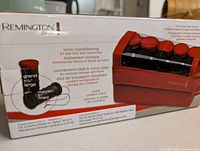 Front of sealed box showing product image, brand, model and features