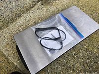 Top view of stainless warming tray with bagged cord and manual on surface