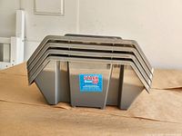 Four nested grey Stack Them Up bins front view