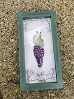 Front view of framed art showing grape relief and Merlot text