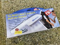 Front of retail box showing Steam Buddy steamer image and claims