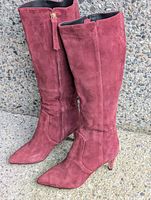 Full view of both boots upright against wall