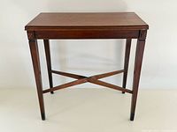 Front three-quarter view of entire side table showing shape, stretcher, legs, and overall condition