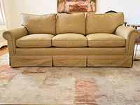 Front view of gold geometric upholstered sofa