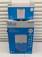 Front of sealed Blueair Blue Pure 211+ air purifier box with separate Blue Pure 211+ filter box stacked on top