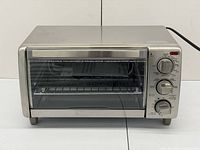 Front view showing stainless steel body, glass door, interior rack, overall condition