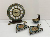 Group shot of mantel clock, pair of trivets, whale bowl