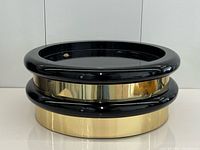 oblique front view showing black gloss top rim and brass-tone mid section