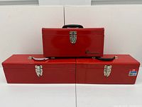 All three red tool boxes closed, showing relative sizes and exterior condition