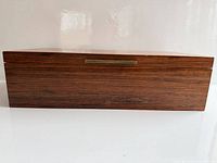 Front view closed showing rosewood veneer and brass pull