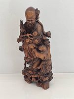 Full front view of carved wood figure