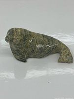 Profile view of the signed Inuit serpentine soapstone walrus sculpture