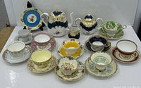 Front view showing teapot set and ten teacup/saucer sets