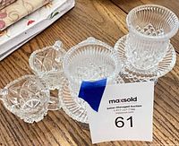 Group shot of all clear cut glass pieces on table surface