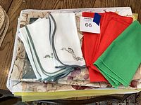 Stack showing packaged tablecloth, runner and assorted napkins