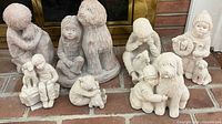 Full group of eight Austin Sculptures on brick hearth