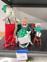 Santa, Mrs. Claus, seated elf child with accessories
