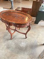Top view carved wood side table showing oval surface detail