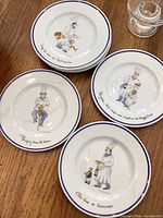 Group of six chef-themed plates and one clear salt dish visible