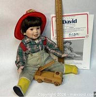 Danbury Mint David doll sitting with ruler, certificate and wooden firetruck