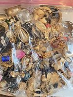 Resealable bag filled with assorted gold-tone and colored costume earrings