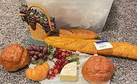 Entire lot showing faux breads, cheese wedge, fruit clusters and resin basket