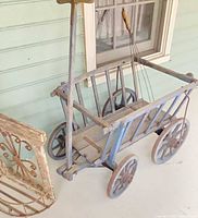 Full view of wooden wagon cart showing wheels, handle, slatted body