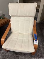 Front view of IKEA Poäng armchair showing cushion and frame