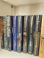 Shelf view of first group of John Grisham hardcovers