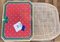 Top view of one red vinyl placemat and one jute placemat