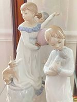 All three Lladro figurines in display case