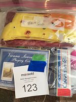 Bagged lot showing socks, Vienna cards, Bluesband harmonica box